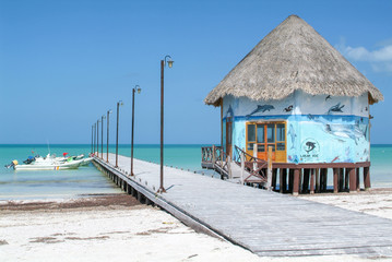 The coast with wooden pier of Holbox Island