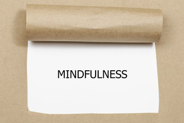 Mindfulness word written under torn paper
