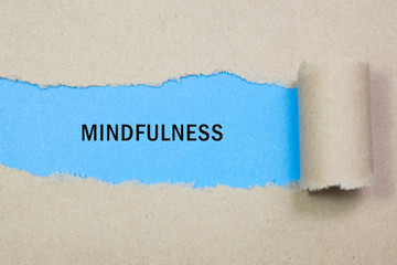 Mindfulness word written under torn paper
