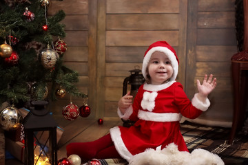 child sitting on the floor in the room in front of a decorated C