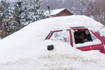 old car covered with snow