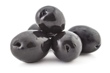 Pile of fresh raw black olives, isolated on white background