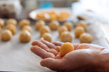 Man kneading marzipan for make panellets.