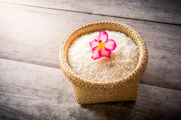 Fototapeta na wymiar basket of jasmine rice on wooden