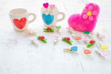 Heart coffee cup, pink heart and wooden clothes peg on white rustic wooden background, Valentine concept