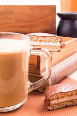 Big mug of hot cocoa with foam and chocolate biscuits