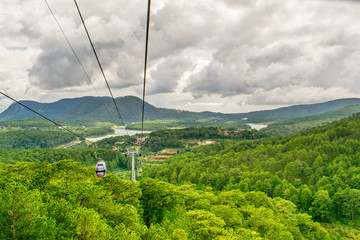 Cable car under pine forest in mountains in Vietnam, Dalat city