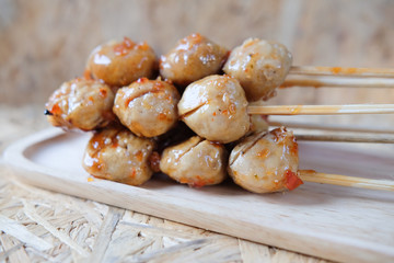 Meatball skewers topped with a sweet sauce.
