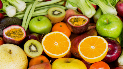 Closeup orange slice with group of ripe fruits and vegetables organic for eating healthy