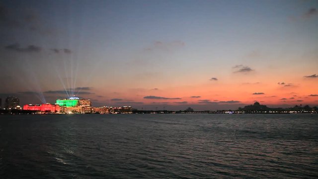 Abu Dhabi skyline at sunset with Emirates Palace lit up for the 43rd National day