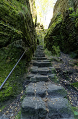 Obraz premium A number of steps of leading upwards in between tall rock structures