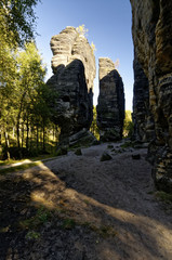 Tall rock formations with a rough terrain in the forefront