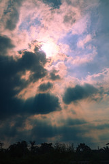 Sun behind clouds background
