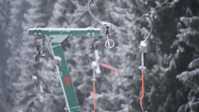 Empty ski lift cable in a ski resort during snowfall