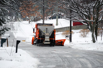 snowplow removing snow on the street after blizzard