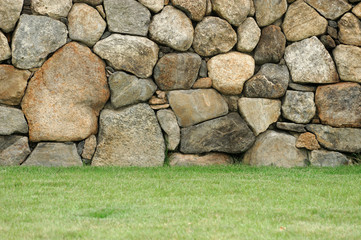 stone wall and front lawn as design background