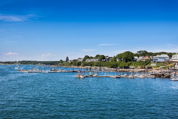 Fototapeta na wymiar Peaks Island homes and docks, West of the ferry terminal, Portland, Maine