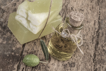 Fototapeta na wymiar natural olive oil soap bars and oil bottle on wooden table