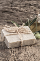 Fototapeta na wymiar natural olive oil soap bar and oil bottle on wooden table
