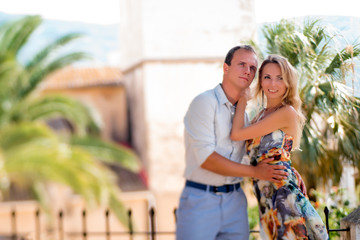 Couple walking outdoors in the city of Denia, Spain on summer da