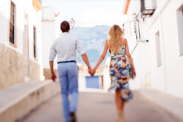 Obraz premium Couple walking outdoors in the city of Denia, Spain on summer da