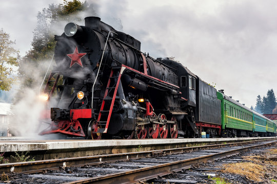 Rare steam train locomotive preparing for departure from railway station