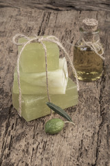 natural olive oil soap and olive on wooden table