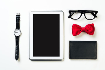 Gentleman kit of tablet watch glasses bow tie and notebook on wooden table