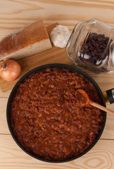 Chili Con Carne in pan on wooden table