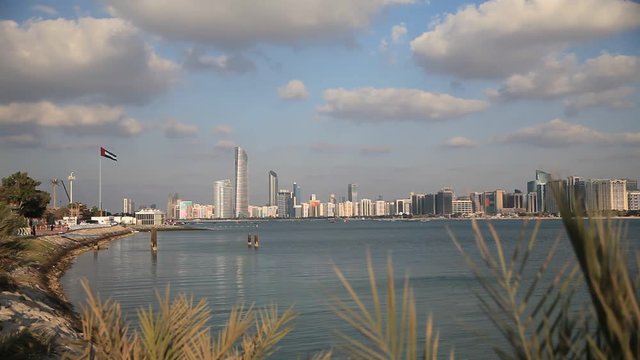Abu Dhabi skyline with clouds. Establishing shot.