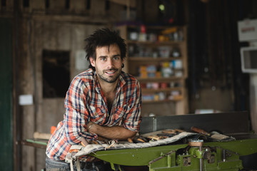 Environmental portrait of a carpenter in his workshop