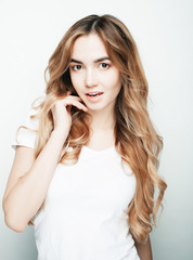 lifestyle and people concept: Young casual woman portrait. Clean face, curly hair. 