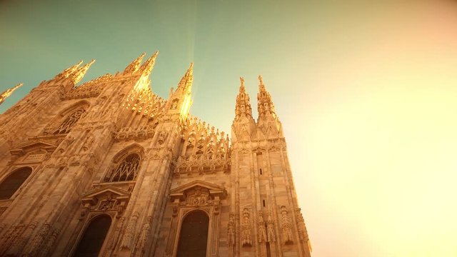 Sunset view of Milan Cathedral (Duomo di Milano) and piazza del Duomo in Milan (Italy) with sunlight and rays from the sun and magic atmosphere