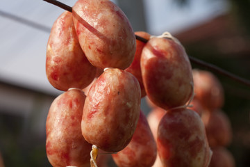 Close up texture of seasoning sun dried Thai home made style sausage using local procedure of food preservation in Thailand.