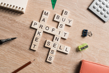 Conceptual business keywords on table with elements of game making crossword