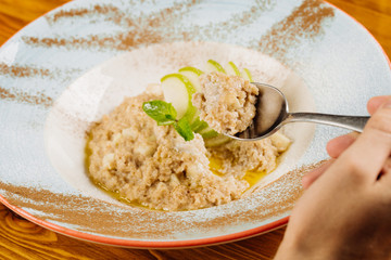 oatmeal with apple and mint in a plate