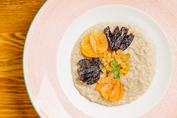 oatmeal with dried fruits  in a plate