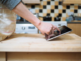 man using digital tablet in the kitchen
