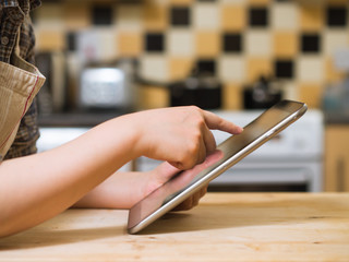 woman using digital tablet in the kitchen