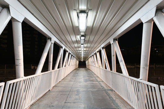 Urban scene of a Pedestrian foot bridge at night in Madrid, Spain.
