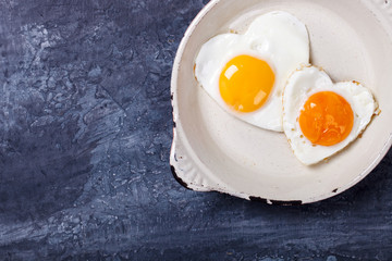 Fried egg in heart shape on the pan.Holiday Valentine's Day.Breakfast. Healthy Food.selective focus.