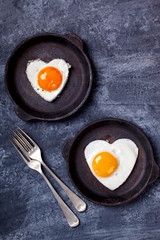 Fried egg in heart shape on the pan.Holiday Valentine's Day.Breakfast. Healthy Food.selective focus.