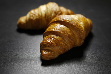 closeup of croissants on black background