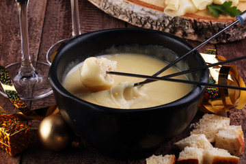 Dipping into a delicious cheese fondue made with a blend of assorted melted cheeses and wine or cider