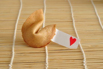 Valentines day. A fortune cookie with a red heart