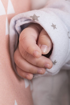 Tiny cute white baby hand close up