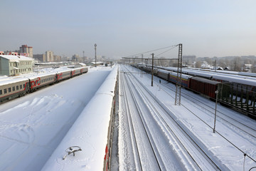 Fototapeta na wymiar Railway in a winter day and snow around
