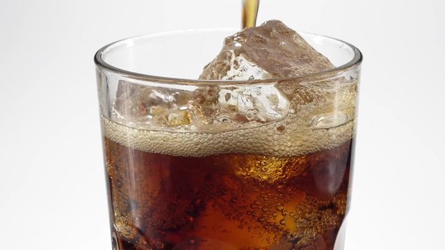 Cola poured in a glass. 4K video.