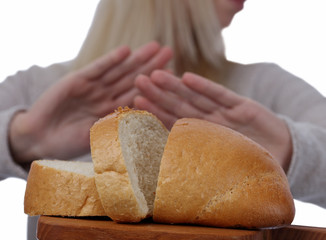 Gluten intolerance and diet concept. Woman refuses to eat white bread. Selective focus on bread