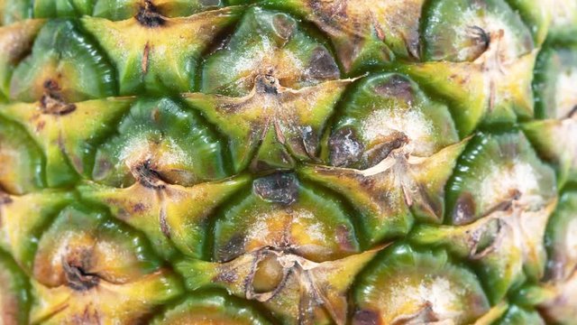 Pineapple rotates on its axis. 4K video.